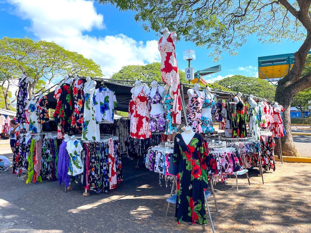 Image of colorful Hawaiian clothing hung up at a booth at the Aloha Swap Meet on Oahu 