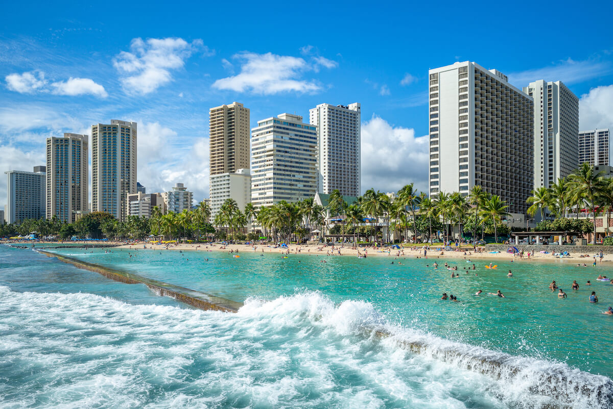 Find out the best things to do in Honolulu Hawaii recommended by top Hawaii blog Hawaii Travel Spot! Image of Waikiki Beach from the water with Honolulu in the background