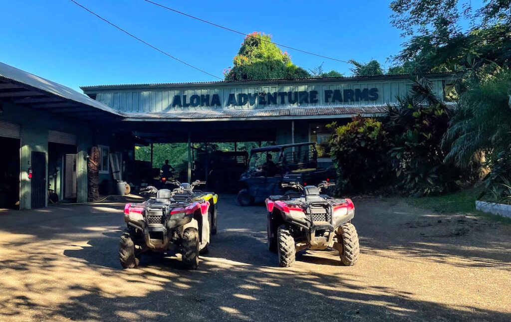 Image of ATVs lined up in front of the Aloha Adventure Farms sign on the Big Island of Hawaii