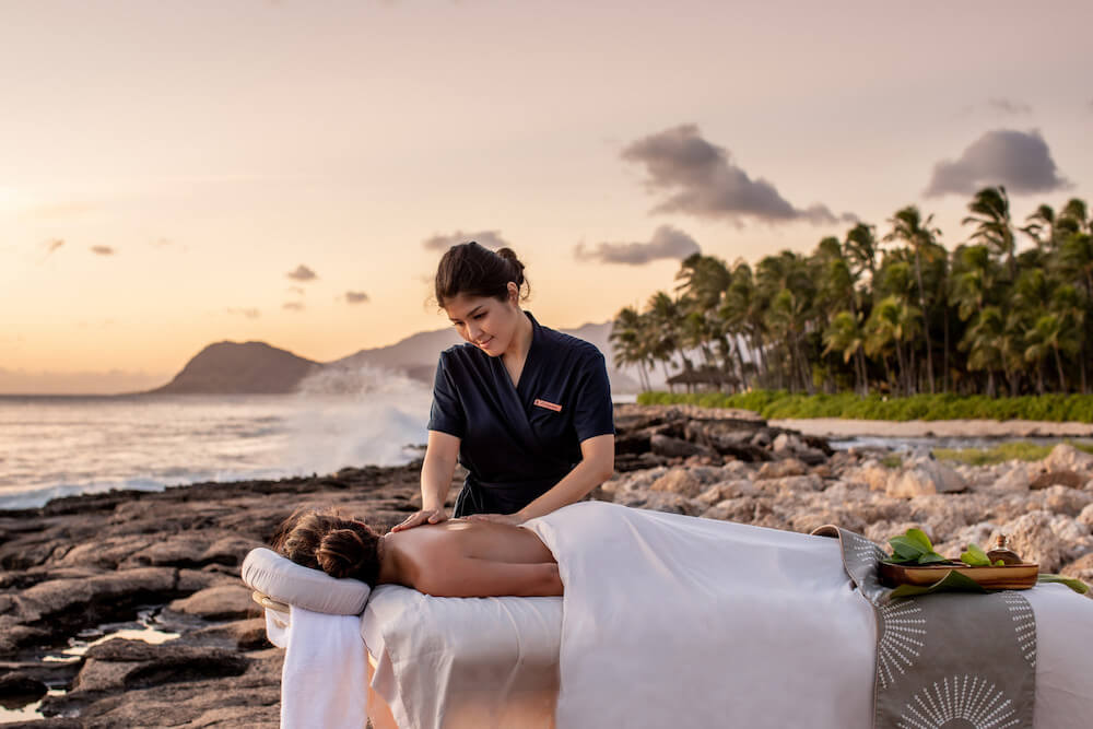Image of someone getting a massage on the beach at the Four Seasons Ko Olina on Oahu