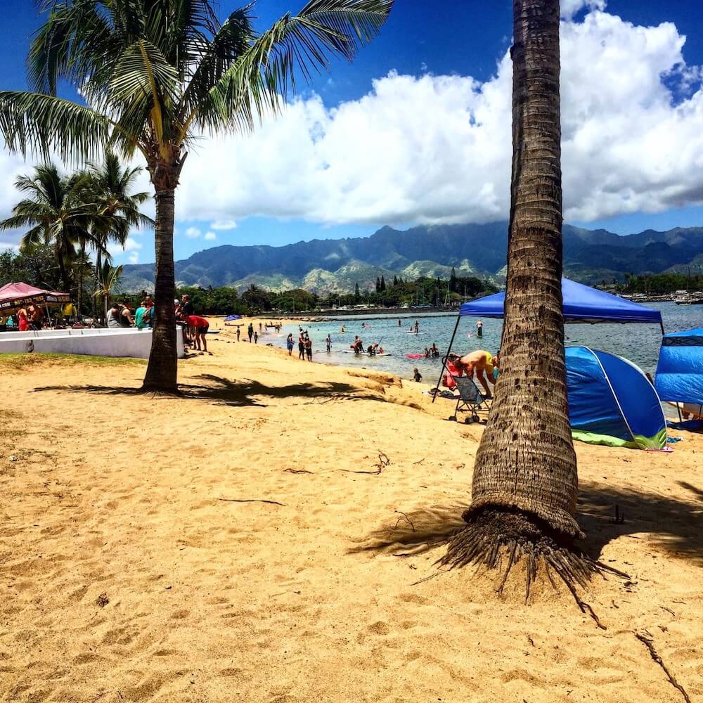 Haleiwa Beach Park in North Shore Oahu. Image of a sandy beach with tents and tourists