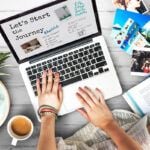 Need a Hawaii vacation planner? Check out this Hawaii trip planning guide by top Hawaii blog Hawaii Travel Spot! Image of someone typing on a laptop with vacation photos, a book, coffee, and pineapple fried rice on the table