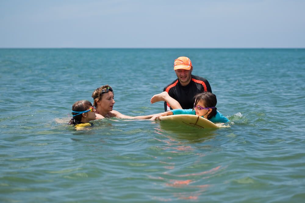 Image of instructors teaching kids to surf