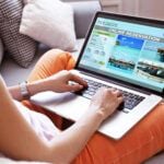 Find out the top planning a trip to Maui tips you need to know by top Hawaii blog Hawaii Travel Spot! Image of a woman using laptop to book hotel online