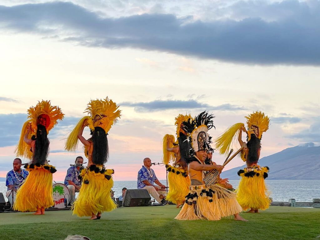 Image of Tahitian dancers wearing yellow costumes at the Feast at Mokapu luau on Maui