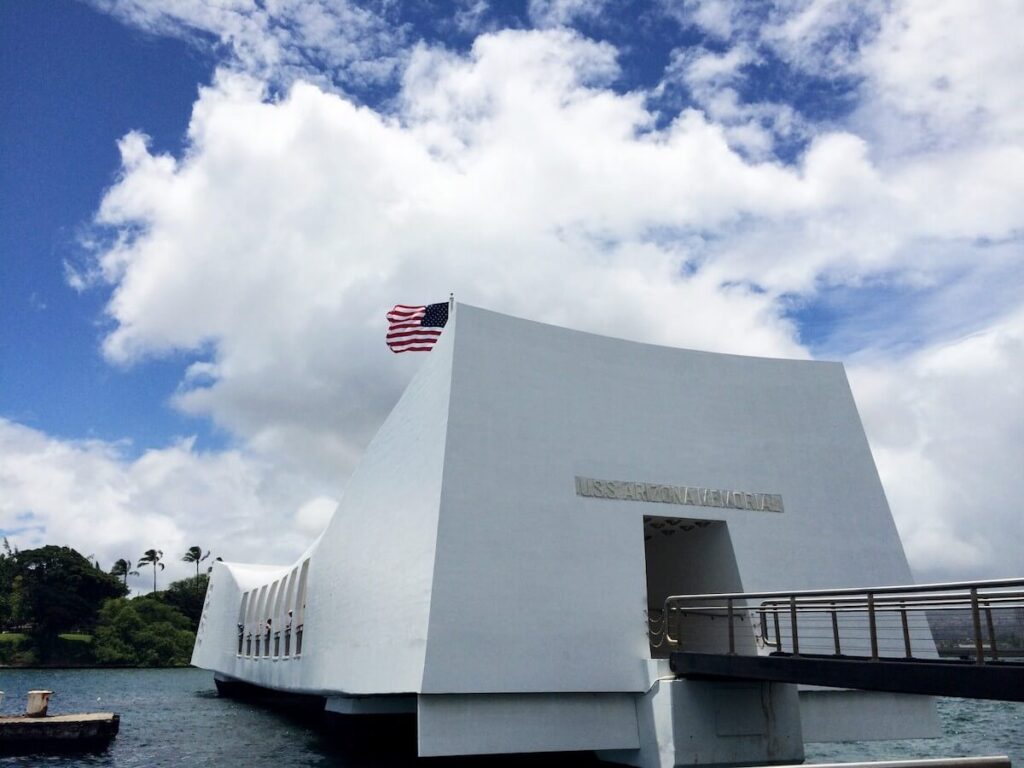 Image of the white USS Arizona Memorial building on the water at Pearl Harbor in Hawaii