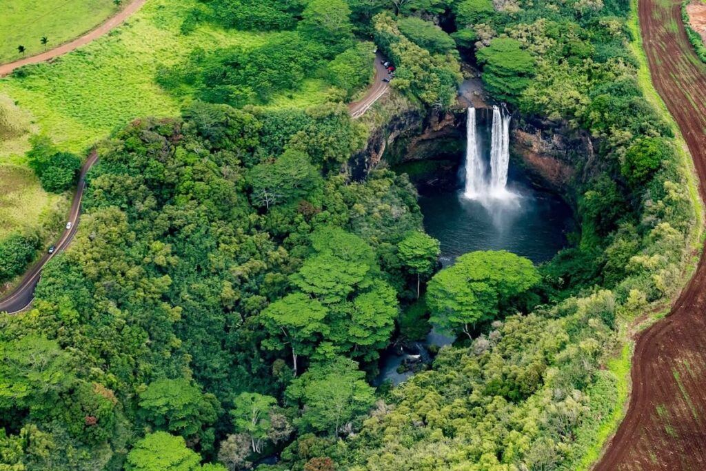 Image of an aerial shot of Wailua Falls on Kauai surrounded by lush trees and vegetation