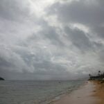 Wondering what is the worst time to visit Hawaii? See what top Hawaii blog Hawaii Travel Spot has to say! Image of Lanikai Beach in a cold rainstorm