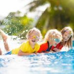 Find out the best resorts in Oahu for families recommended by top Hawaii blog Hawaii Travel Spot! Image of three kids playing in a tropical resort pool