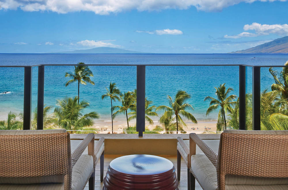 The Four Seasons Maui is one of the best Maui luxury resorts. Image of a lanai overlooking the beach and ocean