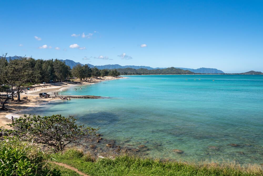 Image of clear blue water and a strip of golden sandy beach at Kailua beach on Oahu