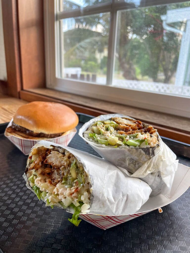 Kauai Cheap Eats: Image of a hamburger and sushi burrito at Kenji Burger on Kauai