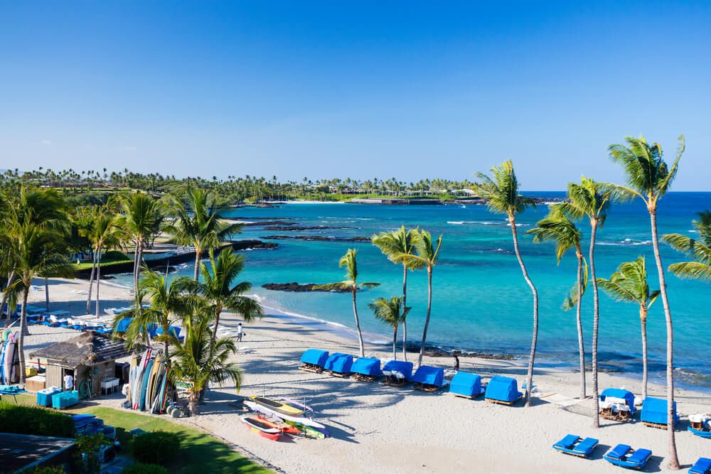 Mauna Lani Beach on the Big Island. Image of a white sand beach with cabanas.