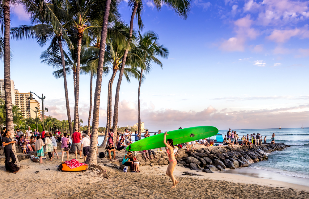 Waikiki beach at sunset. Image o a crowded beach with surfers and tourists