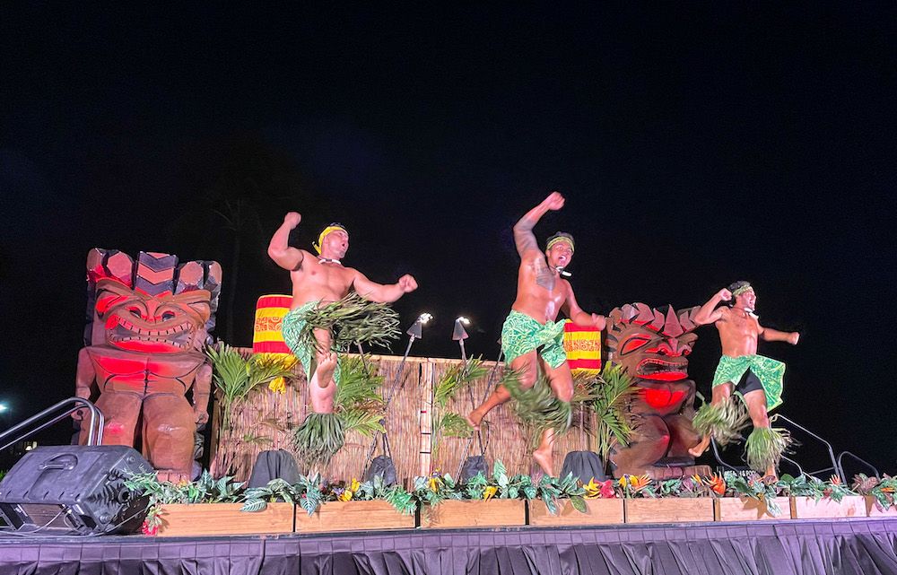 Aulii Luau on Kauai. Image of 3 Samoan men jumping on stage