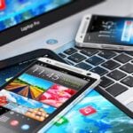 Find out the best Hawaii travel apps recommended by top Hawaii blog Hawaii Travel Spot! Image of cell phones and a computer