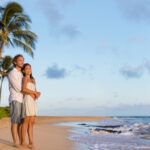 Find out the best Hawaii honeymoon resorts recommended by top Hawaii blog Hawaii Travel Spot! Image of a couple on Poipu Beach in Kauai