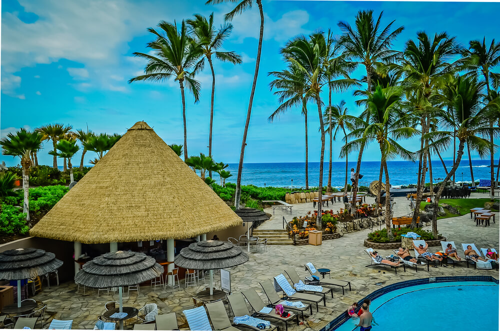 Hilton Waikoloa Village: Image of a pool and lounge chairs with the ocean in the background