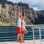 How many days on Kauai do you need? Find out what top Hawaii blog Hawaii Travel Spot says! Image of a couple on a Na Pali Coast cruise
