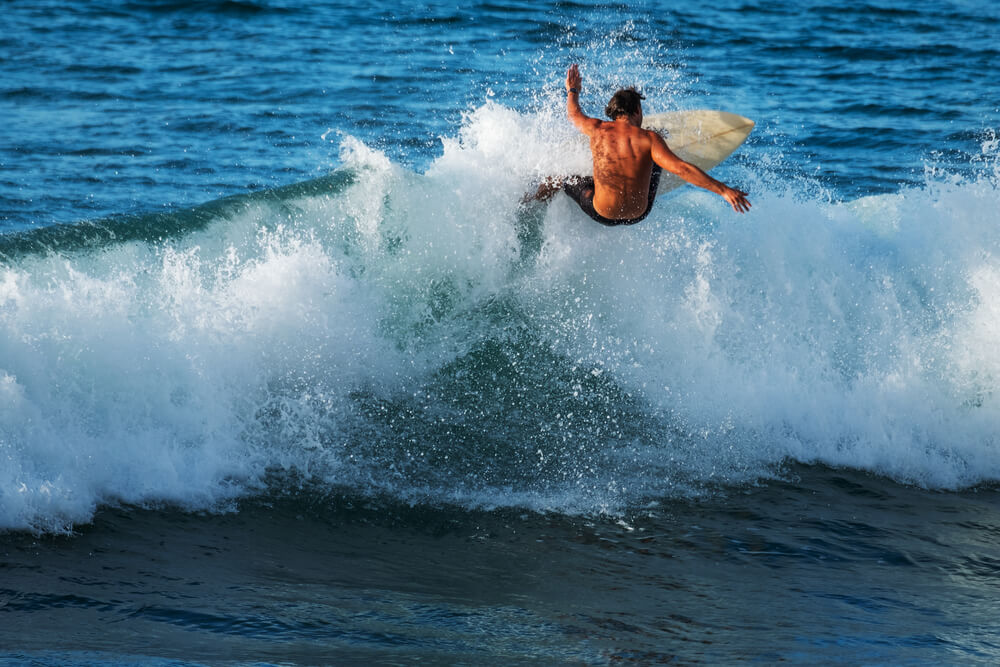Image of a man surfing on North Shore Oahu