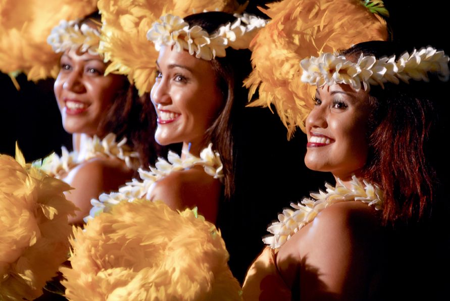 The Old Lahaina Luau is a popular luau on Maui. Image of three hula dancers with plumeria leis