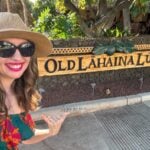 Image of Marcie Cheung in front of the Old Lahaina Luau sign