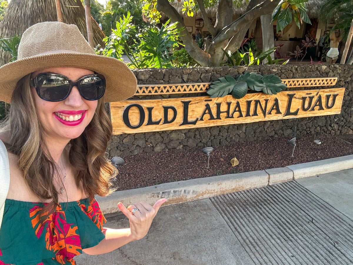 Image of Marcie Cheung in front of the Old Lahaina Luau sign