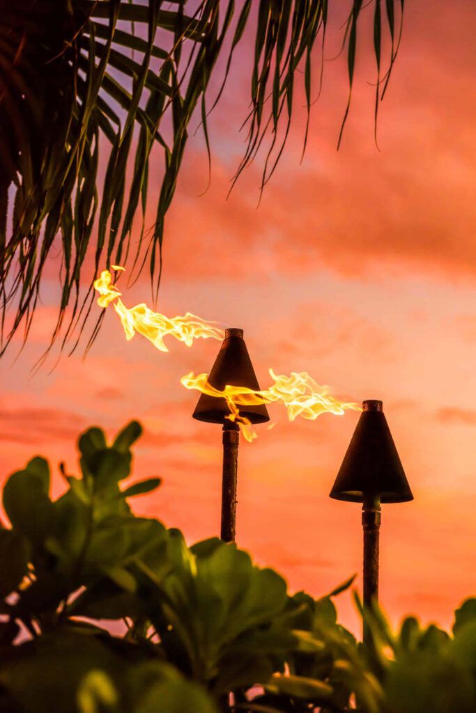 Image of tiki torches at sunset in Hawaii