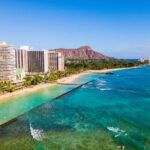 Heading to Oahu on a budget? Check out these cheap places to stay on Oahu recommended by top Hawaii blog Hawaii Travel Spot! Image of Waikiki Beach hotels and Diamon Head