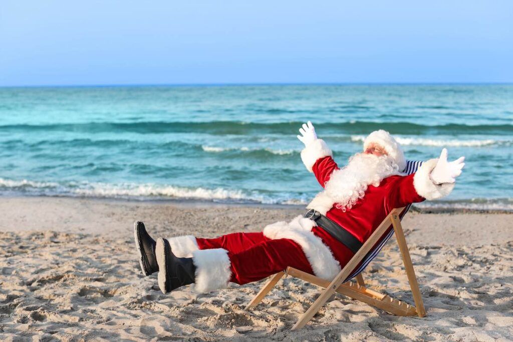 Check out these Hawaiian Christmas traditions recommended by top Hawaii blog Hawaii Travel Spot! Happy Santa Claus resting at sea resort