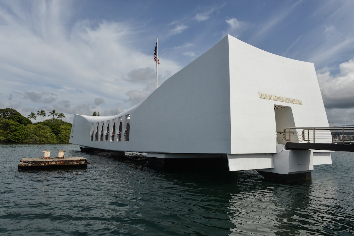 Find out how to get from Waikiki to Pearl Harbor on Oahu by top Hawaii blog Hawaii Travel Spot. Image of USS Arizona Memorial Pearl Harbor Hawaii. Positioned directly over the remains of the ship that continues to release oil.