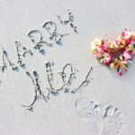 Check out this list of ideas for propsing on the beach in Hawaii by top Hawaii blog Hawaii Travel Spot. Image of the words Marry Me written in sand with a lei in the shape of a heart