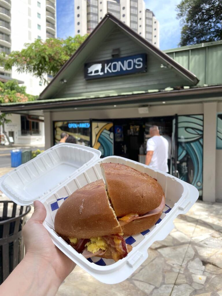 Image of a breakfast sandwich in front of Kono's Waikiki