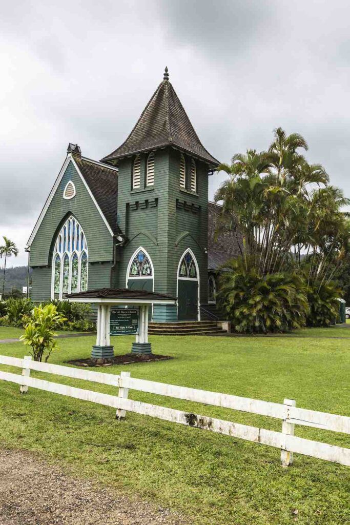 Image of a bright green church with stained glass windows.