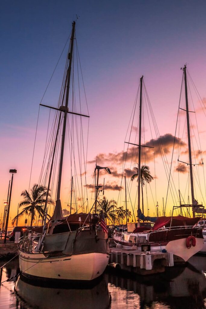 Sailing boats docked at the Ala Wai Harbor at sunset. Ala Wai Yacht Harbor is the largest yacht harbor of Hawaii, situated between Waikiki and downtown Honolulu in Oahu, Hawaii.