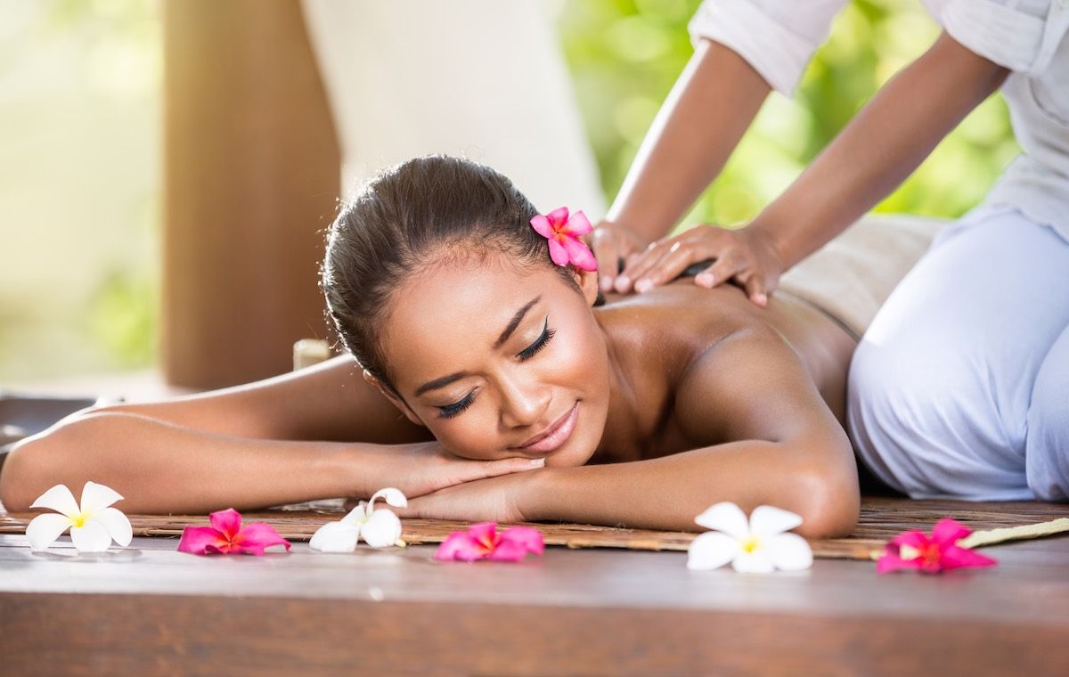 Find out the best spas in Oahu Hawaii recommended by top Hawaii blog Hawaii Travel Spot! Image of Smiling woman enjoying a massage, back massage