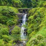 Find out whether Maui or Kauai is the best Hawaiian island according to top Hawaii blog Hawaii Travel Spot! Image of a Road to Hana waterfall on Maui.
