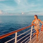 Get all your Hawaii cruises questions answered in this post by top Hawaii blog Hawaii Travel Spot! Image of a woman on a cruise ship deck