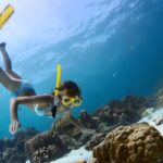 Find out the best Lanai snorkeling tours from Maui recommended by top Hawaii blog Hawaii Travel Spot! Image of a woman snorkeling in the ocean