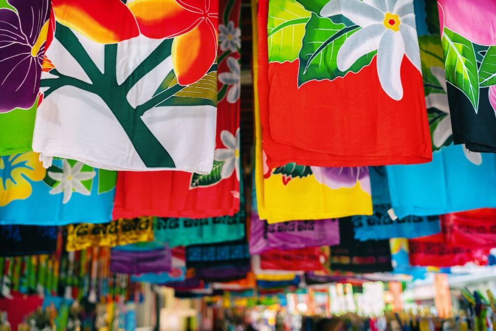 Sarong skirts shop at city market of Papeete, Tahiti, French Polynesia. Colorful clothing pareo wrap hanging for sale as handmade tourism souvenir.