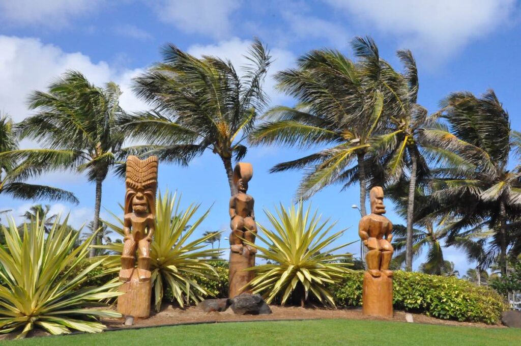 Find out all the best things to do in Hawaii in June recommended by top Hawaii blog Hawaii Travel Spot! Image of tiki statues at the Polynesian Cultural Center on Oahu