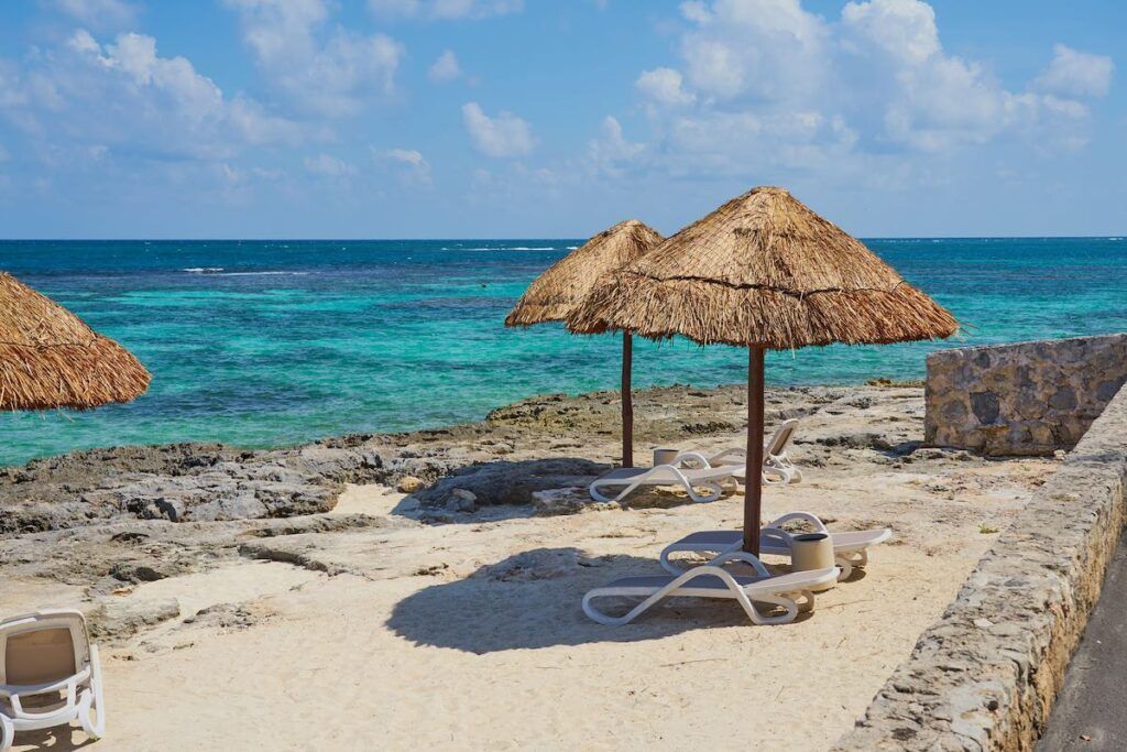 Image of Beach umbrellas made of straw on the shores of the Caribbean Sea in Mexico