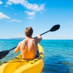 Check out this list of the best Maui kayaking tours recommended by top Hawaii blog Hawaii Travel Spot. Image of Man Kayaking in the Tropical Ocean