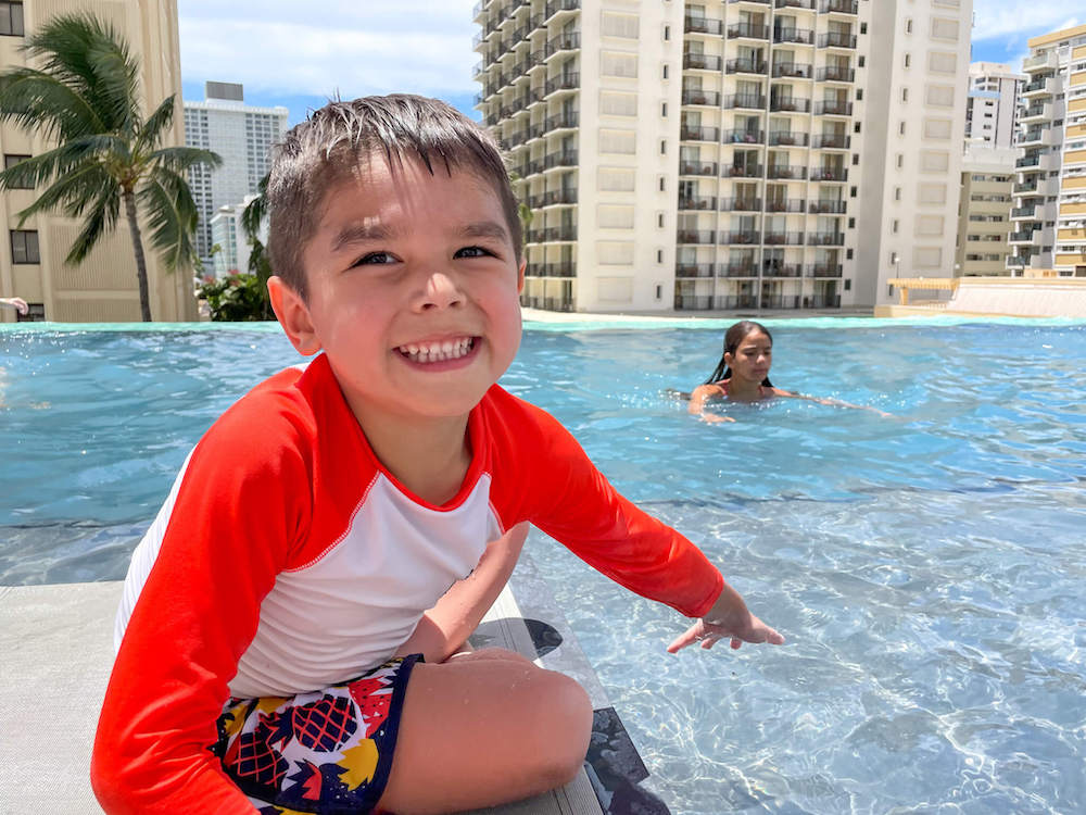 Image of a boy next to an infinity pool in Hawaii