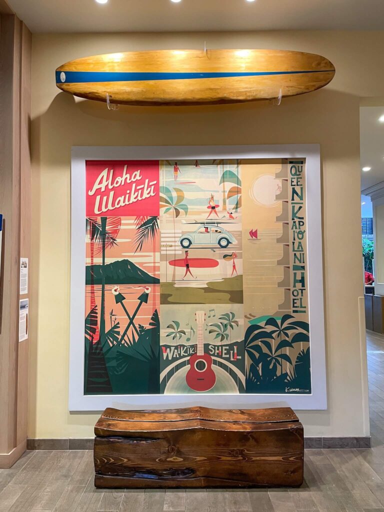 Image of a vintage Hawaii art work and surfboard at the Queen Kapiolani Hotel in Waikiki