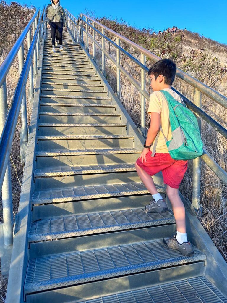 Image of a boy climbing stairs at Diamond Head on Oahu